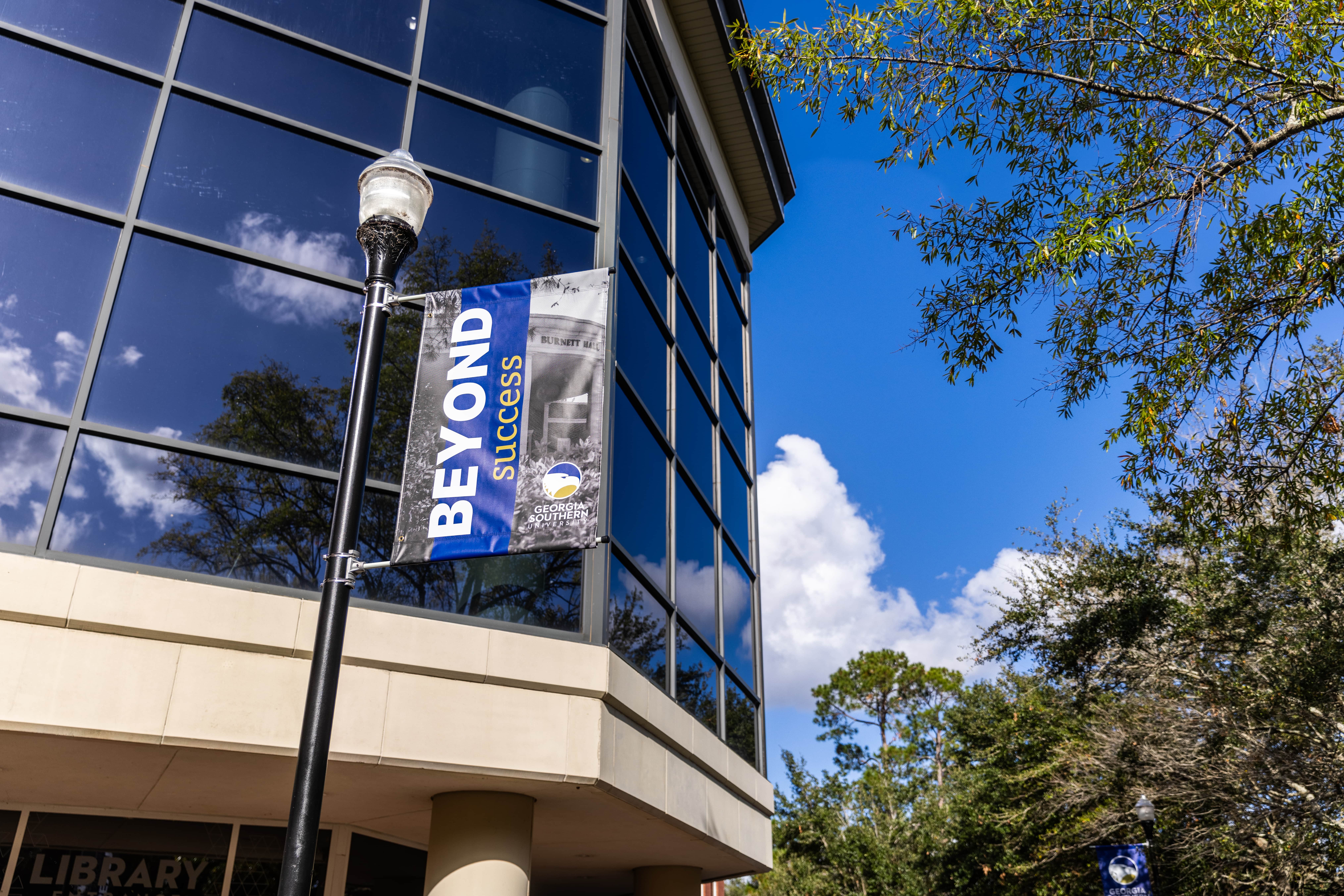 photo of Georgia Southern pole banner with text "Beyond Success"