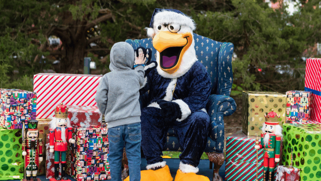 Santa GUS high-fiving a child